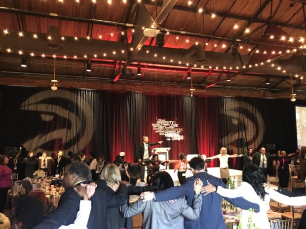 Stage design and AV production by Event Audio Visual Services (EAV) for 'Naturals After Dark' event with truss, LED screens, and theatrical lighting.