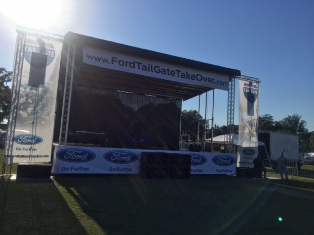 Outdoor stage production by Event Audio Visual Services (EAV) for the Ford Tailgate Takeover, including truss, branded scrims, and audio rig