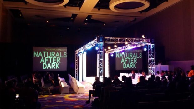 Stage design and AV production by Event Audio Visual Services (EAV) for 'Naturals After Dark' event with truss, LED screens, and theatrical lighting.