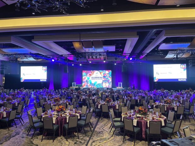 Banquet-style event with vibrant center stage